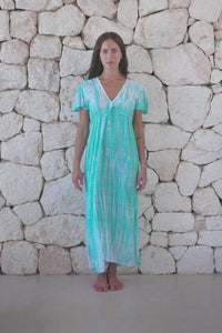 Womens full length tie dye summer dress in aqua blue featuring a hand beaded v neckline, pull ties under the bust, short sleeves and side splits