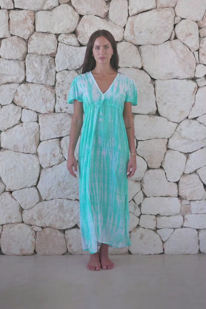 Womens full length tie dye summer dress in aqua blue featuring a hand beaded v neckline, pull ties under the bust, short sleeves and side splits