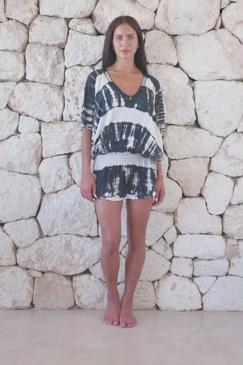 Womens stylish, super soft, lightweight, short length kaftan tie dye dress in black and cream featuring an elasticated waist and hand beaded v neckline