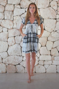 Relaxed, super soft, lightweight, short length tie dye dress in grey featuring a v neckline, pull tie detail and side pockets