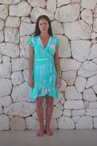 Womens super soft, lightweight, short length wrap tie dye dress in aqua blue featuring a ruffle detail and a self tie fastening