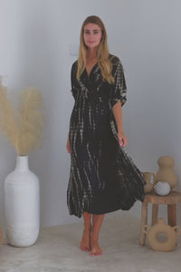 Womens mid length tie dye dress in black featuring a hand beaded neckline, kimono sleeves, elasticated waist and pockets