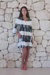 Womens short length tie dye tunic dress in black and cream featuring a tiered silhouette, 3/4 length sleeves and pockets 