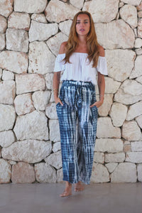 Stylish, super soft wide leg culotte style tie-dye trousers in navy and white featuring an elasticated waist, belt detail and pockets for a flattering and comfortable fit