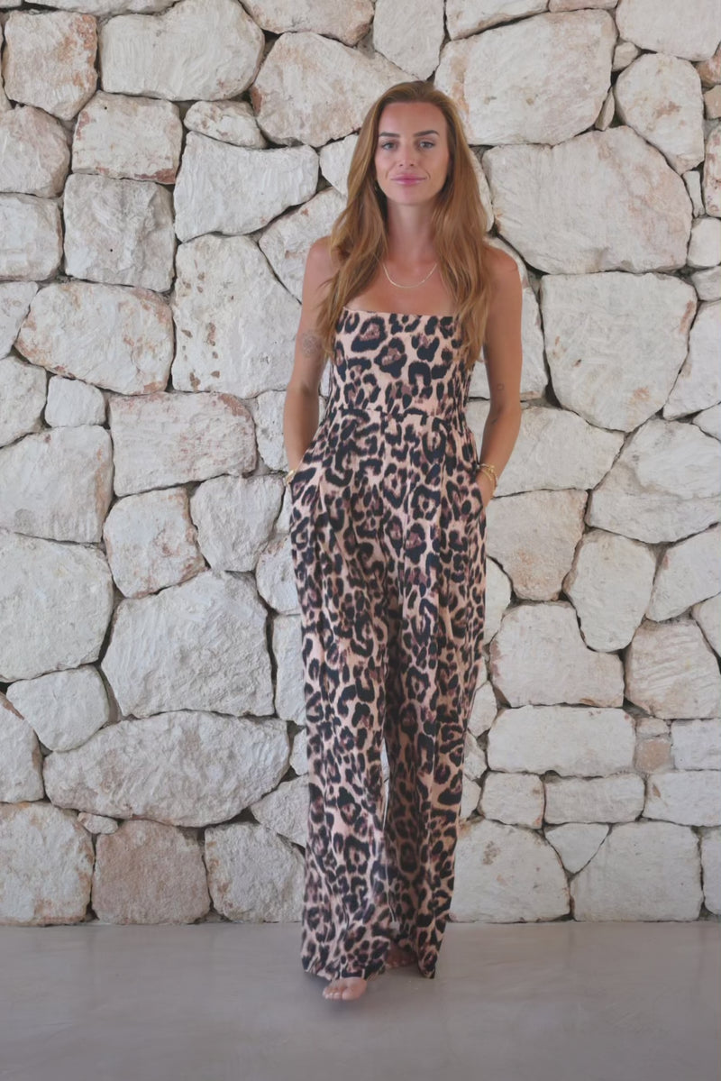Womens super soft, lightweight, strapless wide leg jumpsuit in leopard print featuring a halterneck strap detail, elasticated back, flat front with side pockets