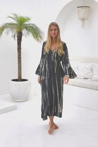 womens full length tie dye summer dress in black featuring a hand beaded v neckline, pull ties under the bust, trumpet sleeves, pockets and side splits