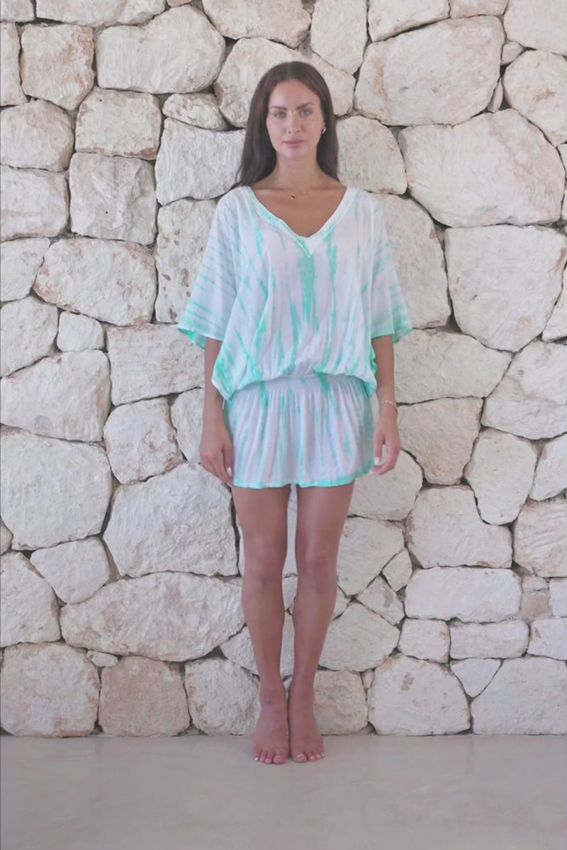 Womens stylish, super soft, lightweight, short length kaftan tie dye dress in aqua blue featuring an elasticated waist and hand beaded v neckline
