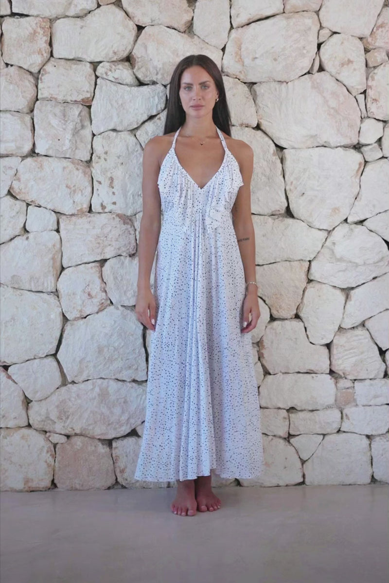 Womens stylish midi length halter neck dress in white polka dot featuring a deep V at the back with a pull tie detail under the bust