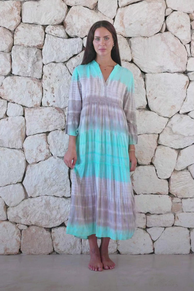 Womens super soft, lightweight, tunic style long length tie dye dress in aqua blue featuring 3/4 length trumpet sleeves and side pockets