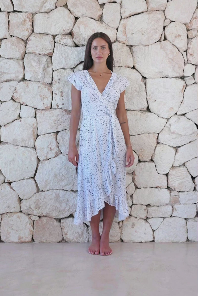 Womens stylish midi length tie dye dress in white polka dot featuring a ruffle detail and self tie fastening 