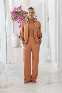 Womens stylish, super soft 100% cotton Rachel Trousers in brick, featuring an elasticated waist and pockets for a flattering and comfortable fit