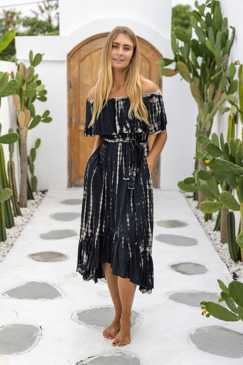 womens mid length tie dye dress in black featuring an off the shoulder frill, elasticated waist, detachable belt and side pockets