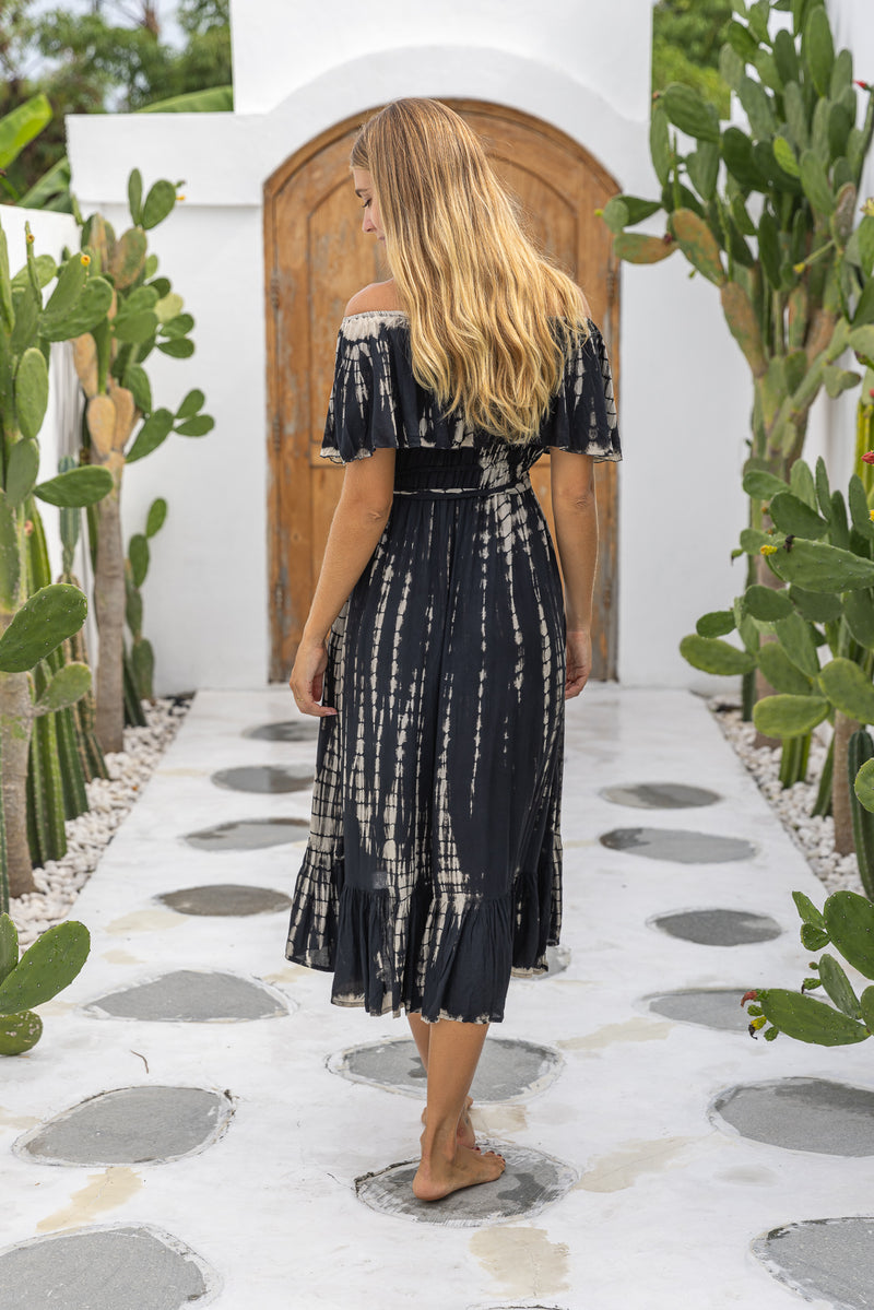 womens mid length tie dye dress in black featuring an off the shoulder frill, elasticated waist, detachable belt and side pockets