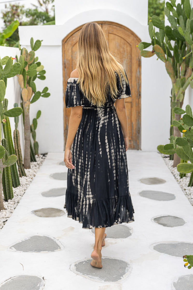 womens mid length tie dye dress in black featuring an off the shoulder frill, elasticated waist, detachable belt and side pockets