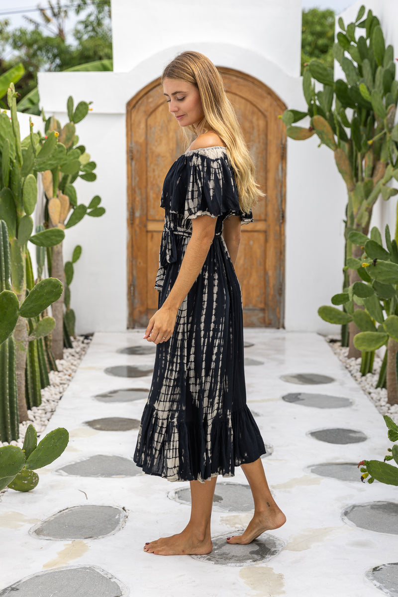 womens mid length tie dye dress in black featuring an off the shoulder frill, elasticated waist, detachable belt and side pockets