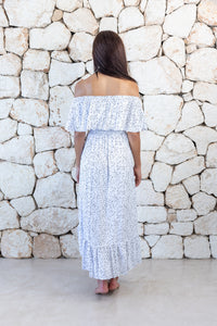 Womens elegant long length dress in white polka dot featuring an off the shoulder frill and elasticated waist