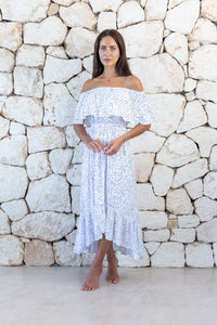 Womens elegant long length dress in white polka dot featuring an off the shoulder frill and elasticated waist