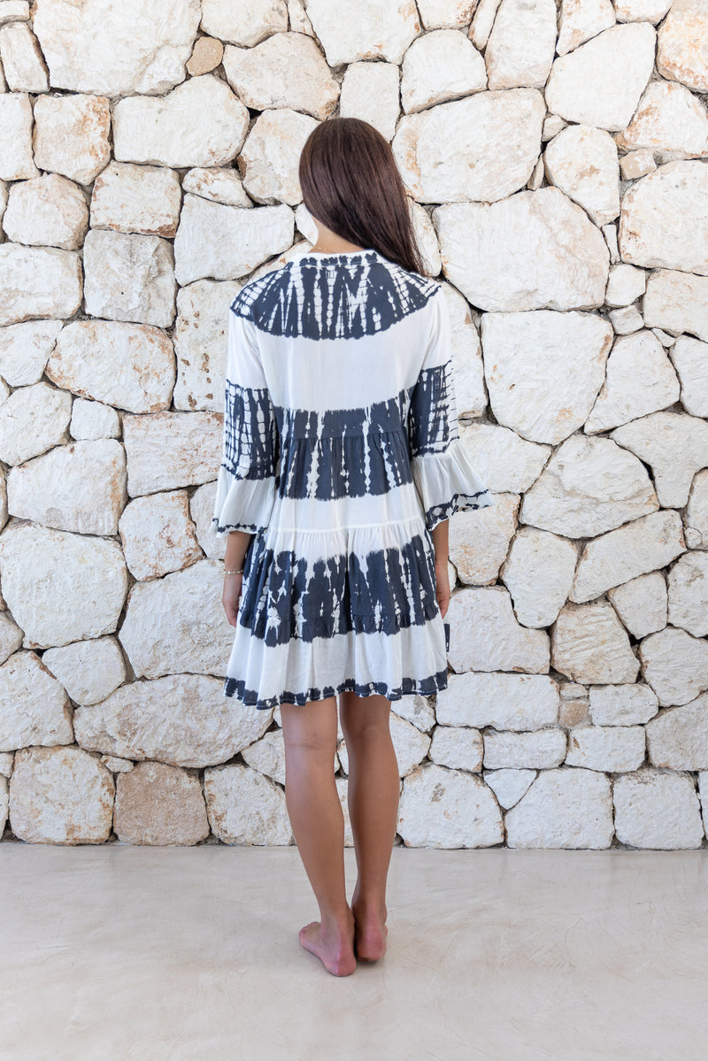 Womens short length tie dye tunic dress in black and cream featuring a tiered silhouette, 3/4 length sleeves and pockets 