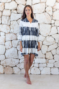 Womens short length tie dye tunic dress in black and cream featuring a tiered silhouette, 3/4 length sleeves and pockets 