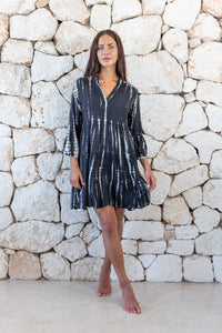 Womens short length tie dye tunic dress in black featuring a tiered silhouette, 3/4 length sleeves and pockets 