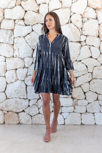 Womens short length tie dye tunic dress in black featuring a tiered silhouette, 3/4 length sleeves and pockets 
