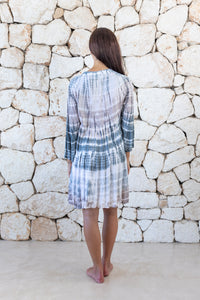 Womens short length tie dye tunic dress in light grey featuring a tiered silhouette, 3/4 length sleeves and pockets 