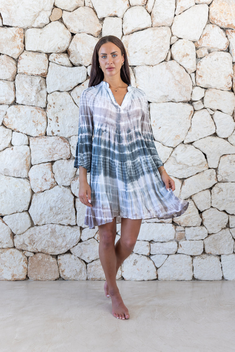 Womens short length tie dye tunic dress in light grey featuring a tiered silhouette, 3/4 length sleeves and pockets 