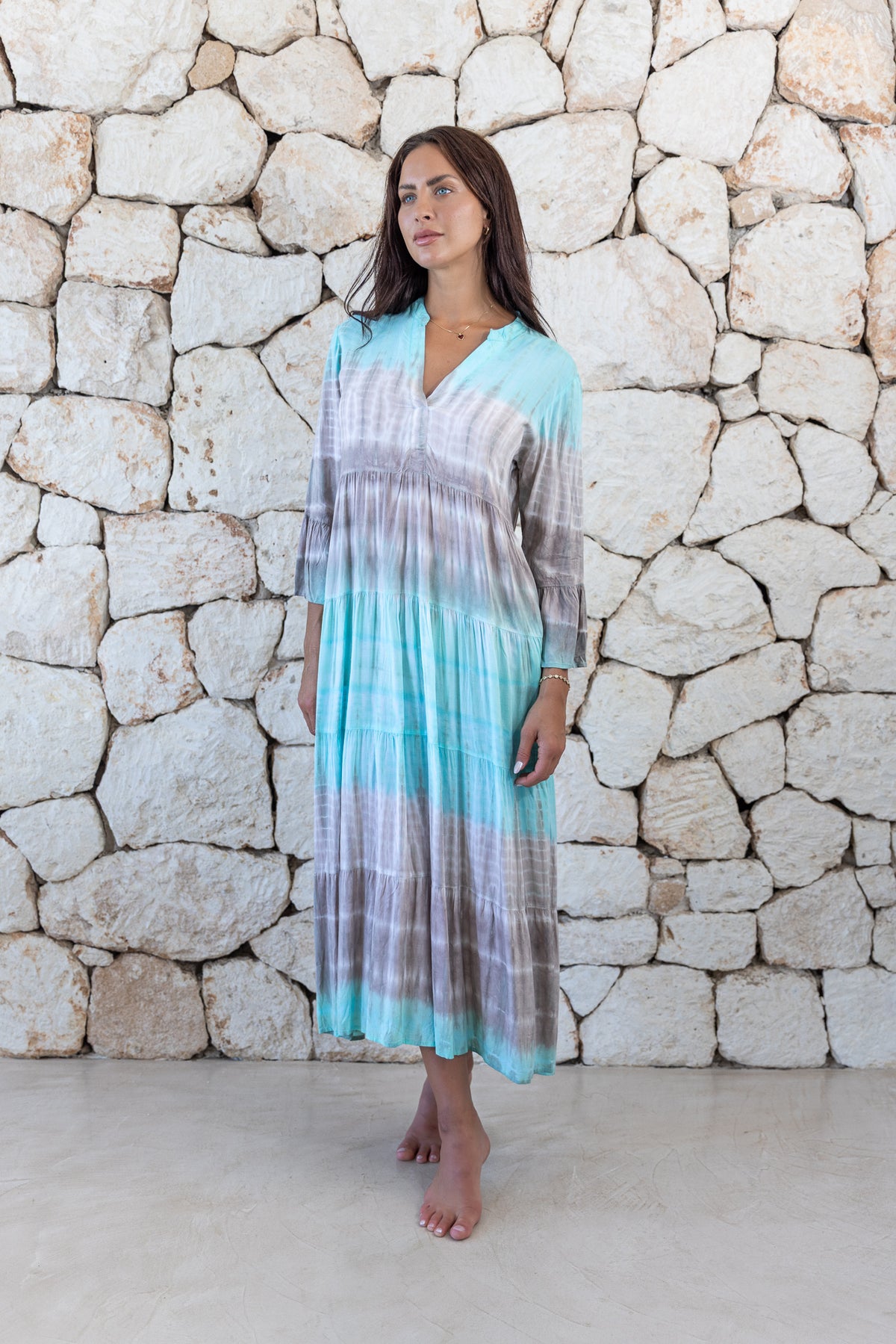 Womens super soft, lightweight, tunic style long length tie dye dress in aqua blue featuring 3/4 length trumpet sleeves and side pockets