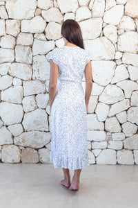 Womens stylish midi length tie dye dress in white polka dot featuring a ruffle detail and self tie fastening 